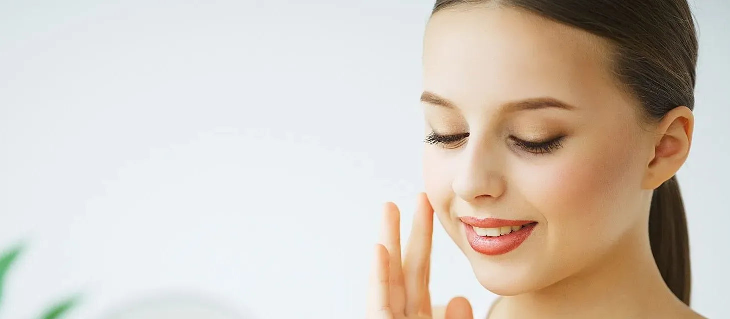 A gentle skin cleanser bottle surrounded by natural ingredients, promoting radiant skin and healthy glow.