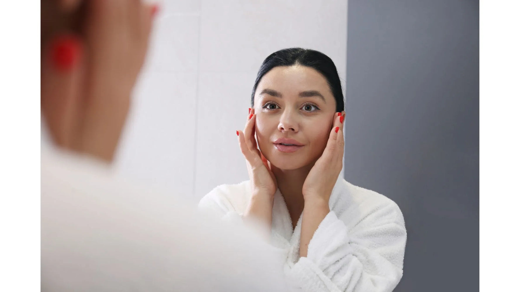 A woman applying kojic acid serum to her face, highlighting its benefits for radiant skin.