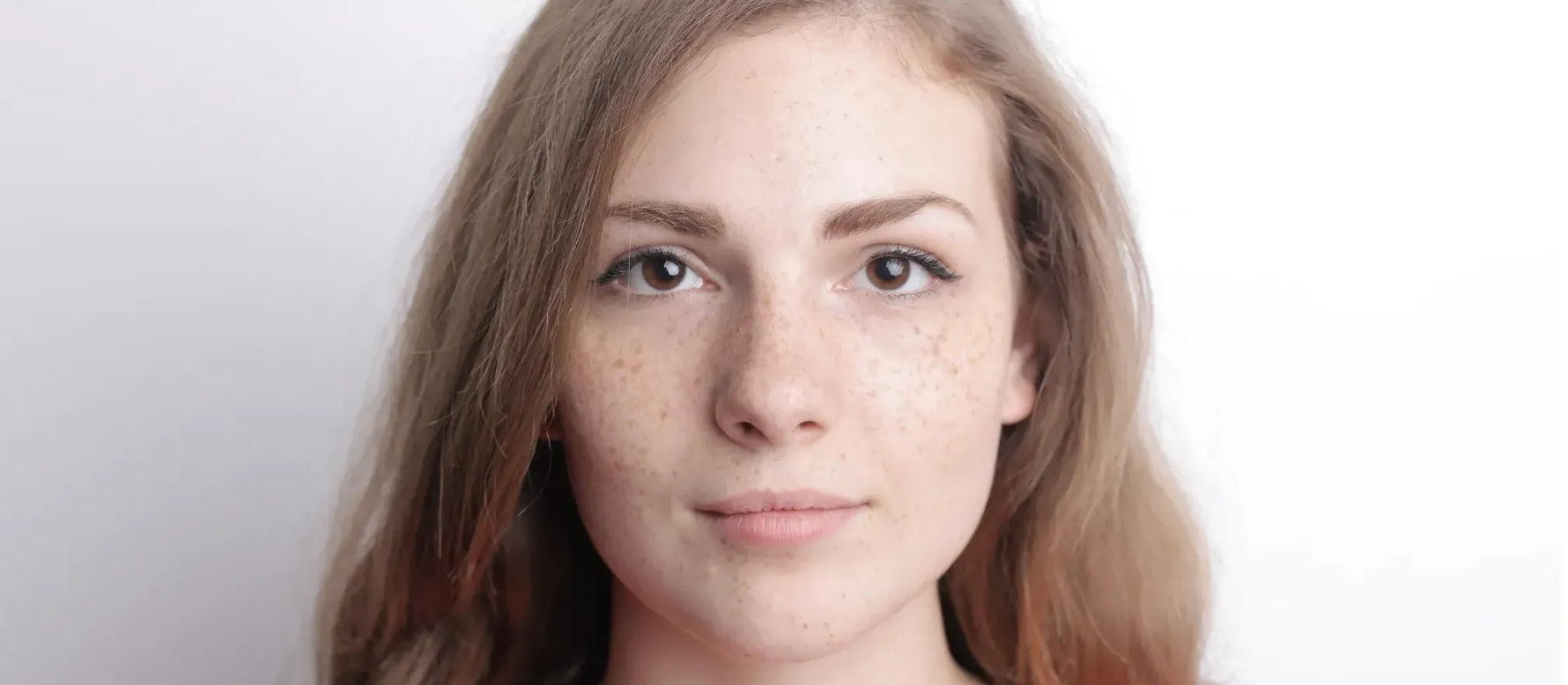 A selection of lightweight moisturizers ideal for oily, acne-prone skin on a wooden surface.
