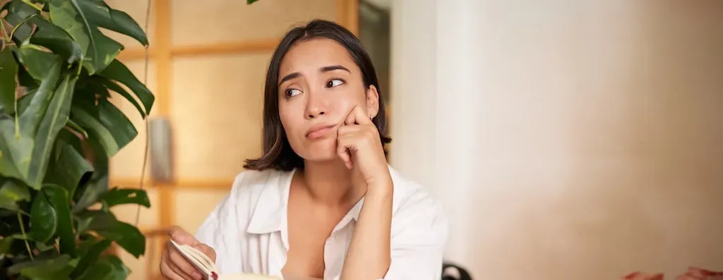 A person applying a moisturizer to their face, highlighting the connection between hydration and acne management.