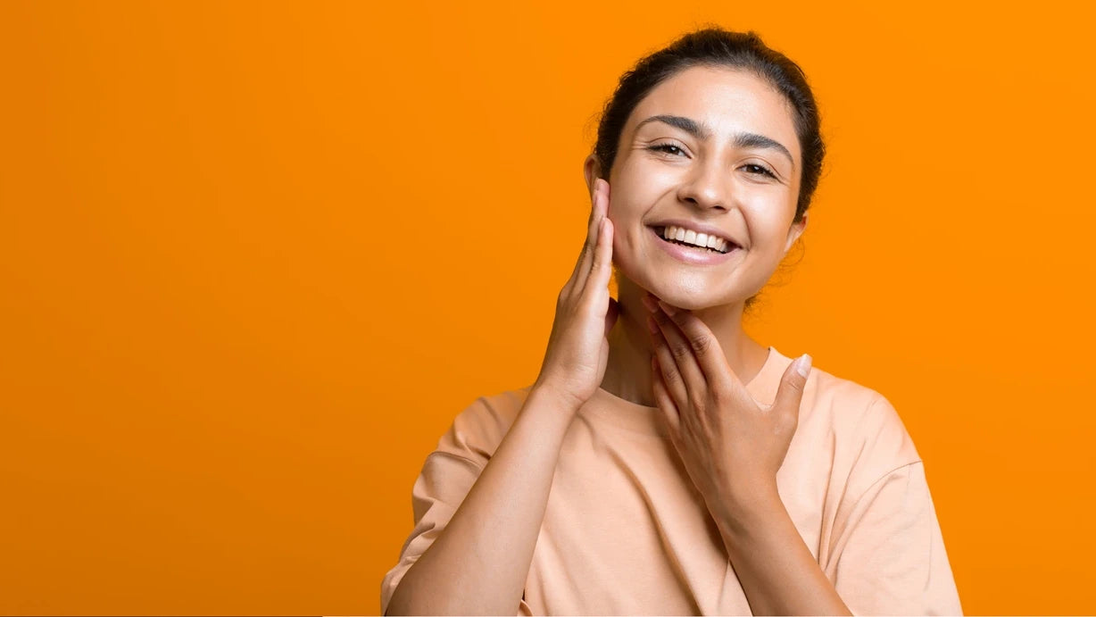 A woman applying a topical treatment to her face, targeting hormonal acne breakouts effectively.