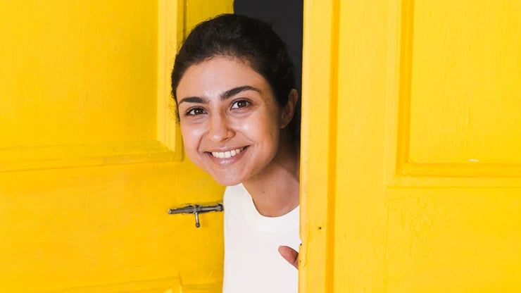 A person applying moisturizer to their face, highlighting skincare for acne-prone skin.