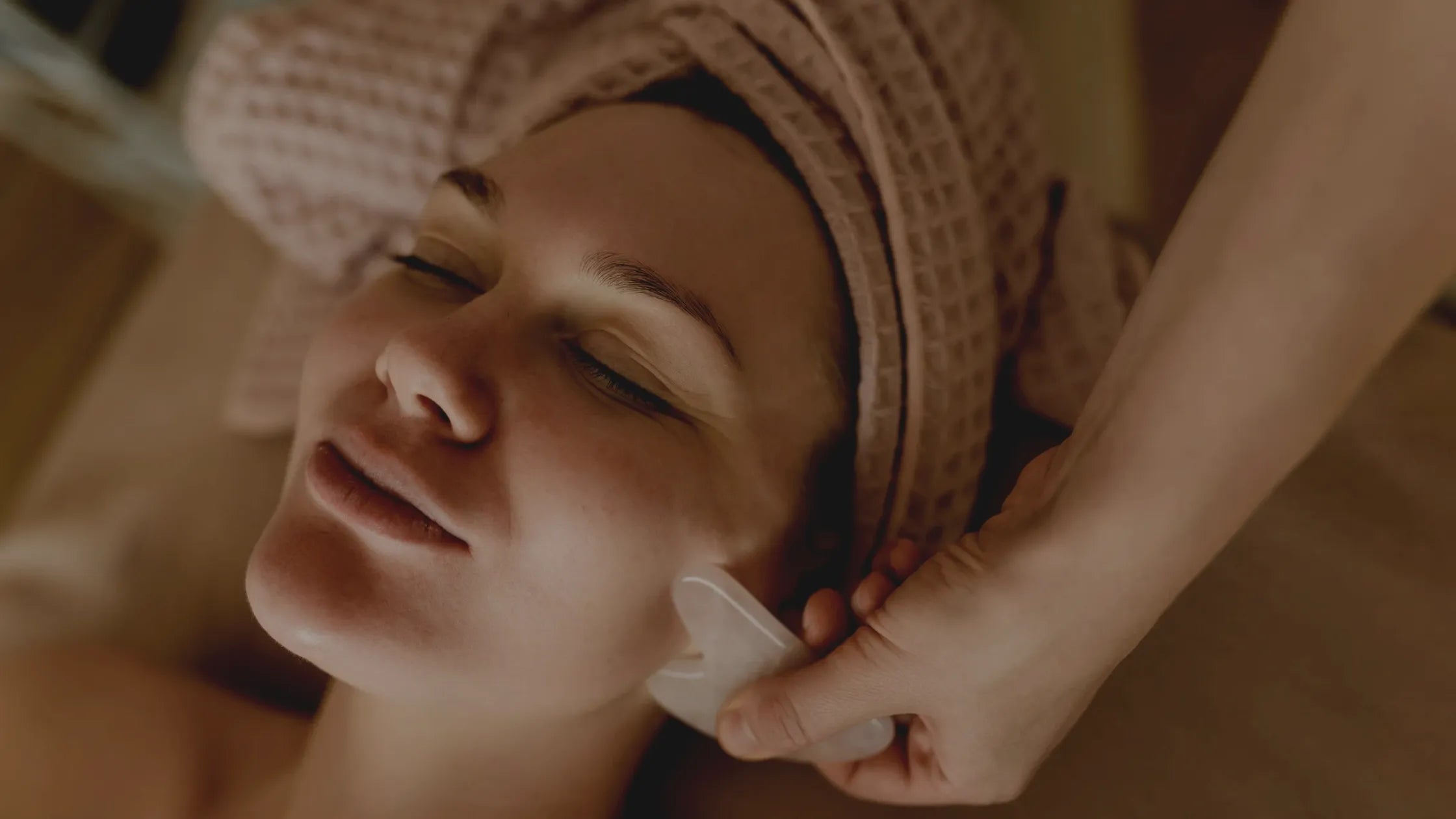 A woman applying effective creams for dry flaky skin on her face, showcasing hydration and skin care routine.