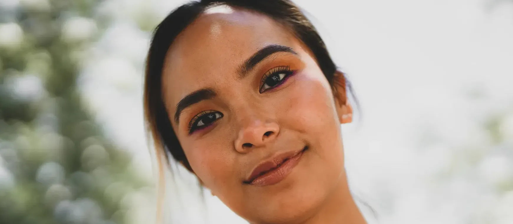 A person applying a vitamin C cleanser to their face, highlighting daily skincare routine benefits.