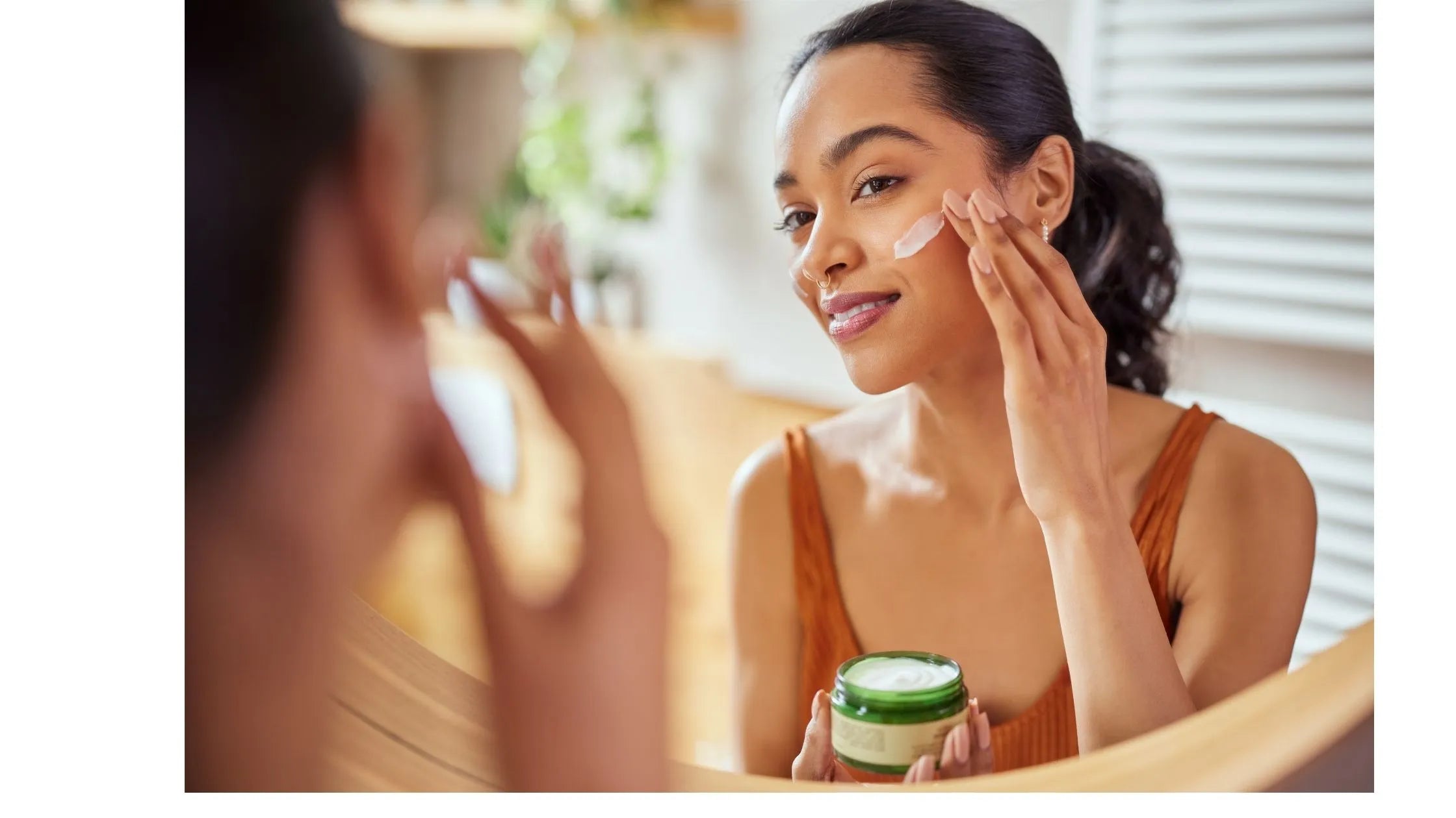 A woman applying salicylic acid serum to her face, showcasing its benefits for radiant skin.