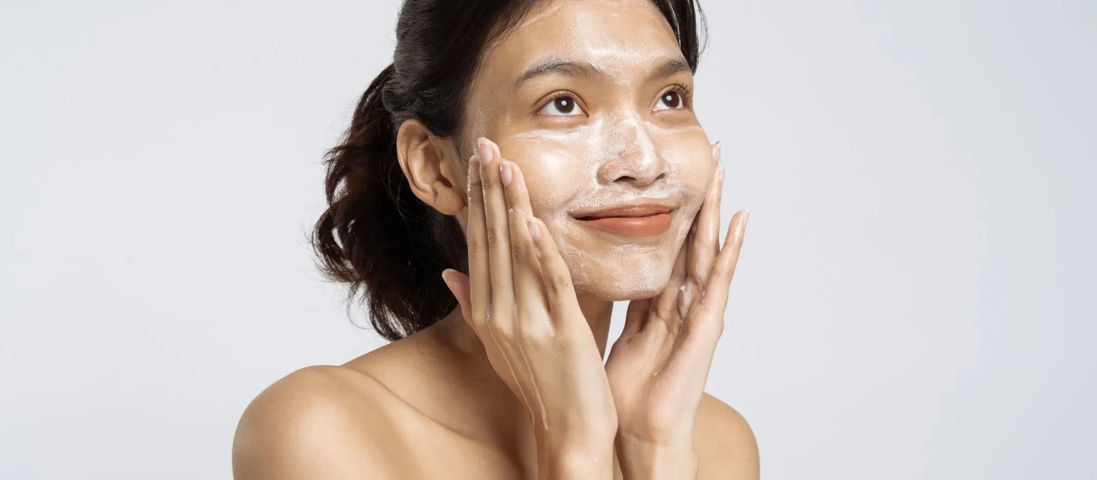 A person applying acne treatment on their face, showcasing effective skincare for clear skin.