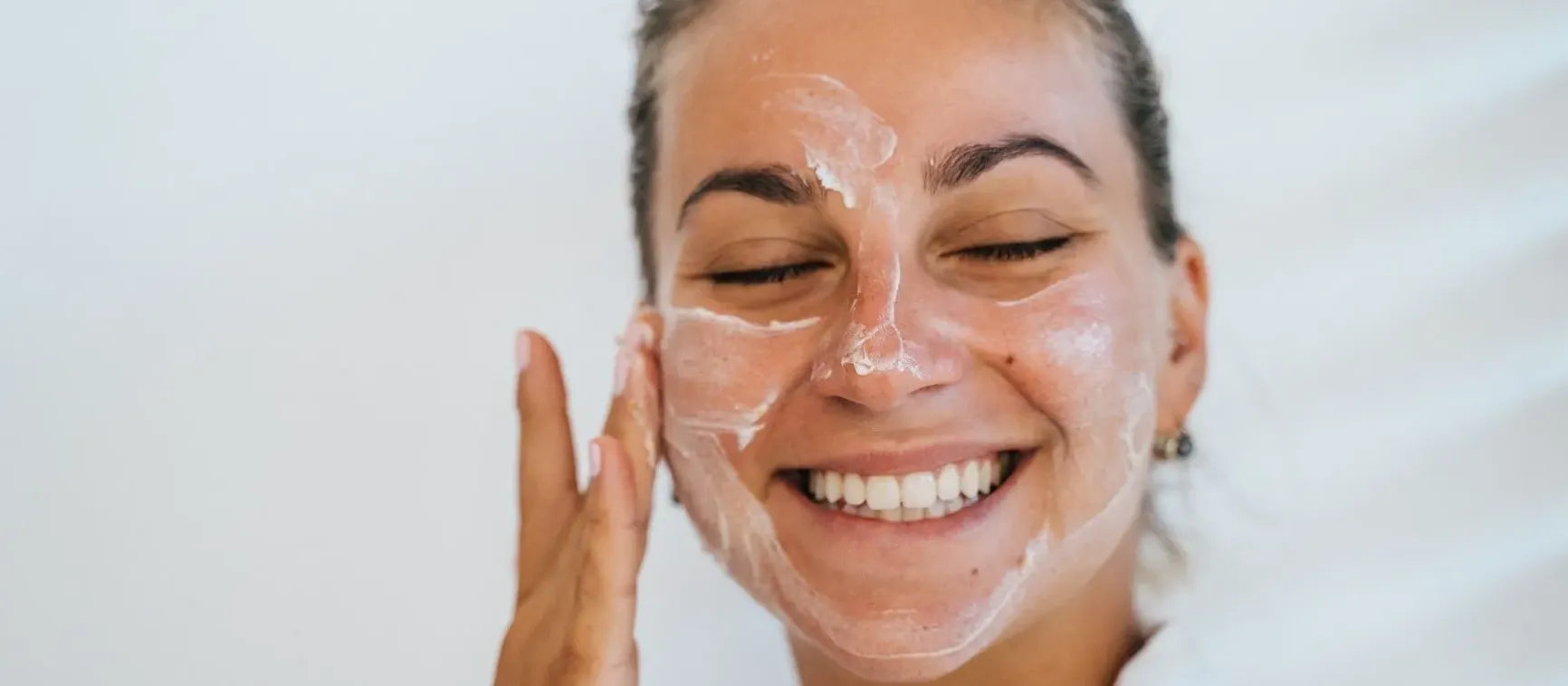 A person applying acne face wash, exploring its effectiveness for clear skin and acne treatment.