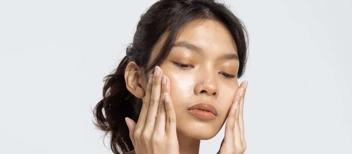 A bottle of effective acne face wash surrounded by fresh ingredients for clear skin.